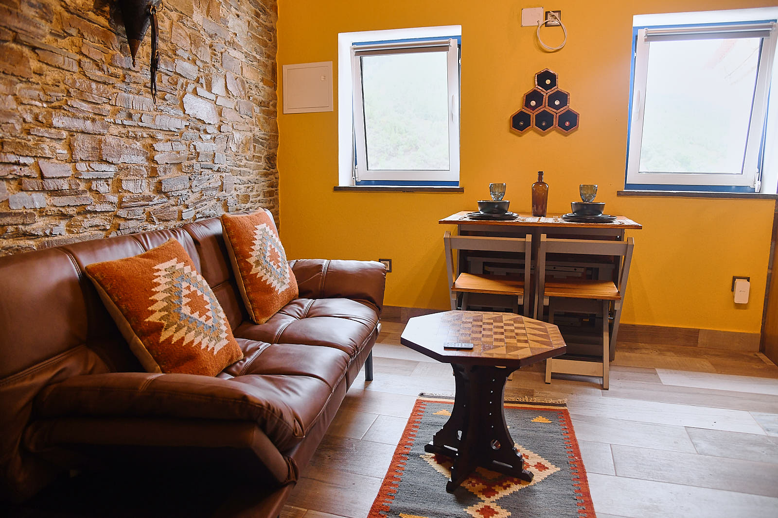 Living room with leather sofa and kilim cushions