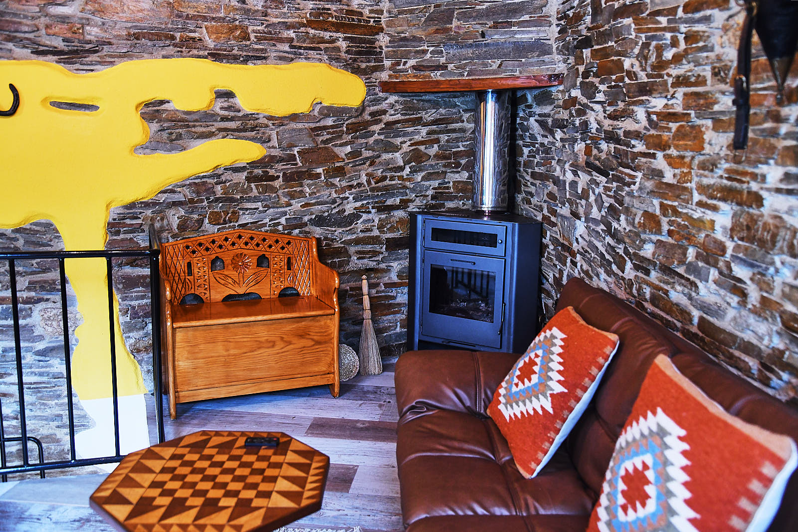 Wood burner with carved bench and traditional decor